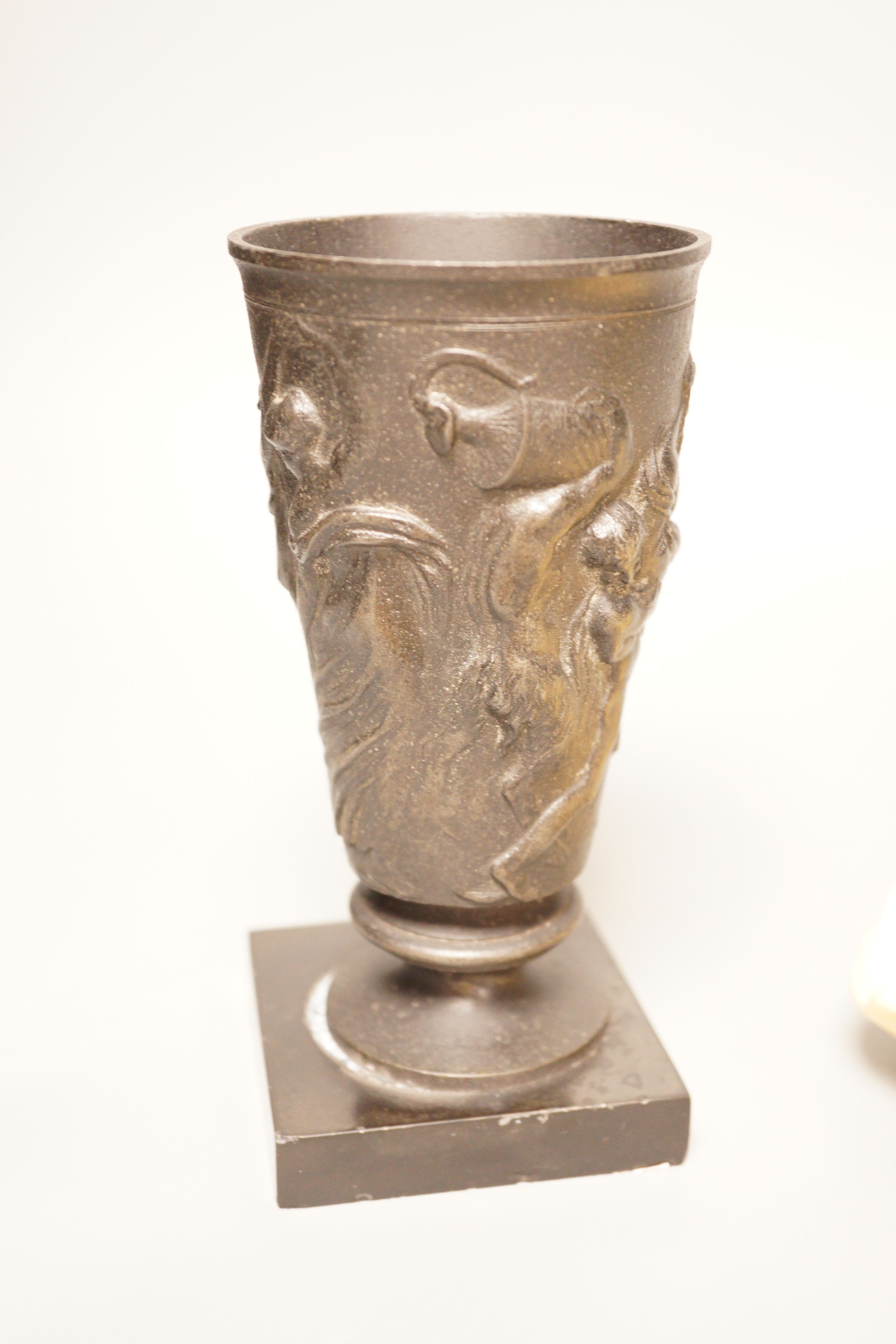 A pair of gilt resin figural wall appliques, signed, and a 19th century cast iron and slate beaker, Sotheby’s label to base, tallest 17cm